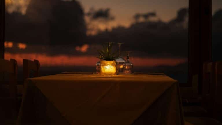 Elegant restaurant table set for dinner at sunset, illustrative dining photograph