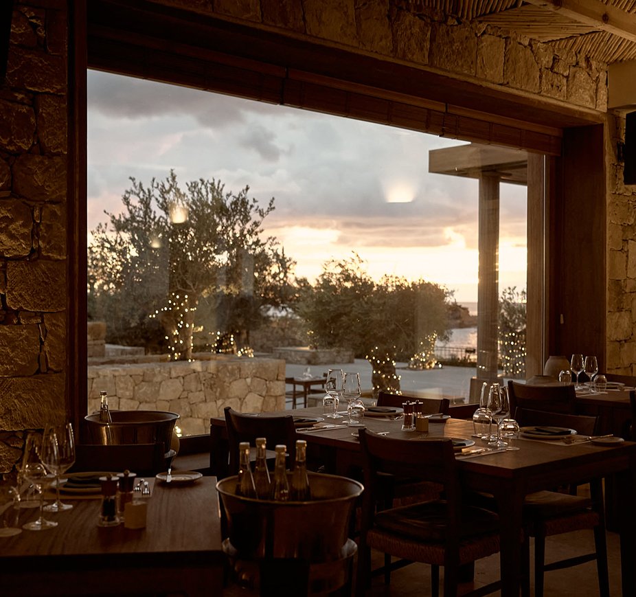 Tables beside the sea-view windows at PHOS Restaurant
