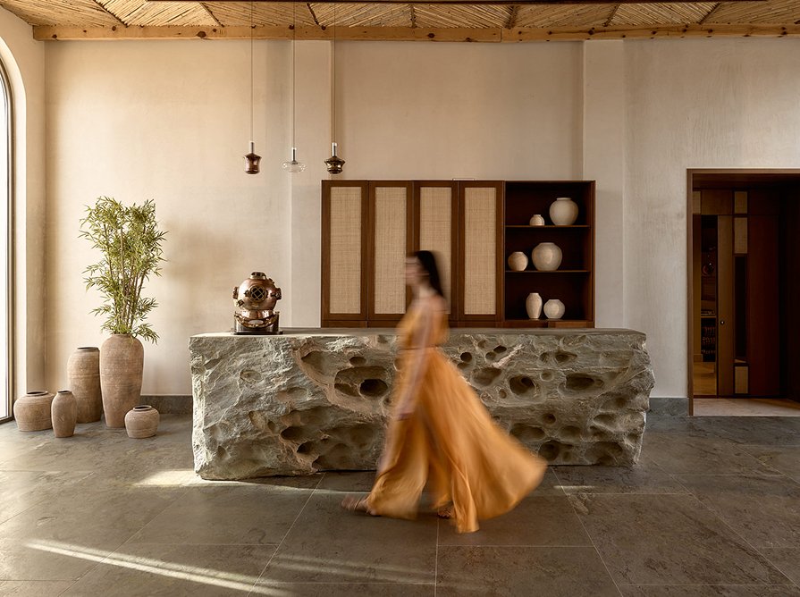 A guest walking through the reception at PHOS Restaurant