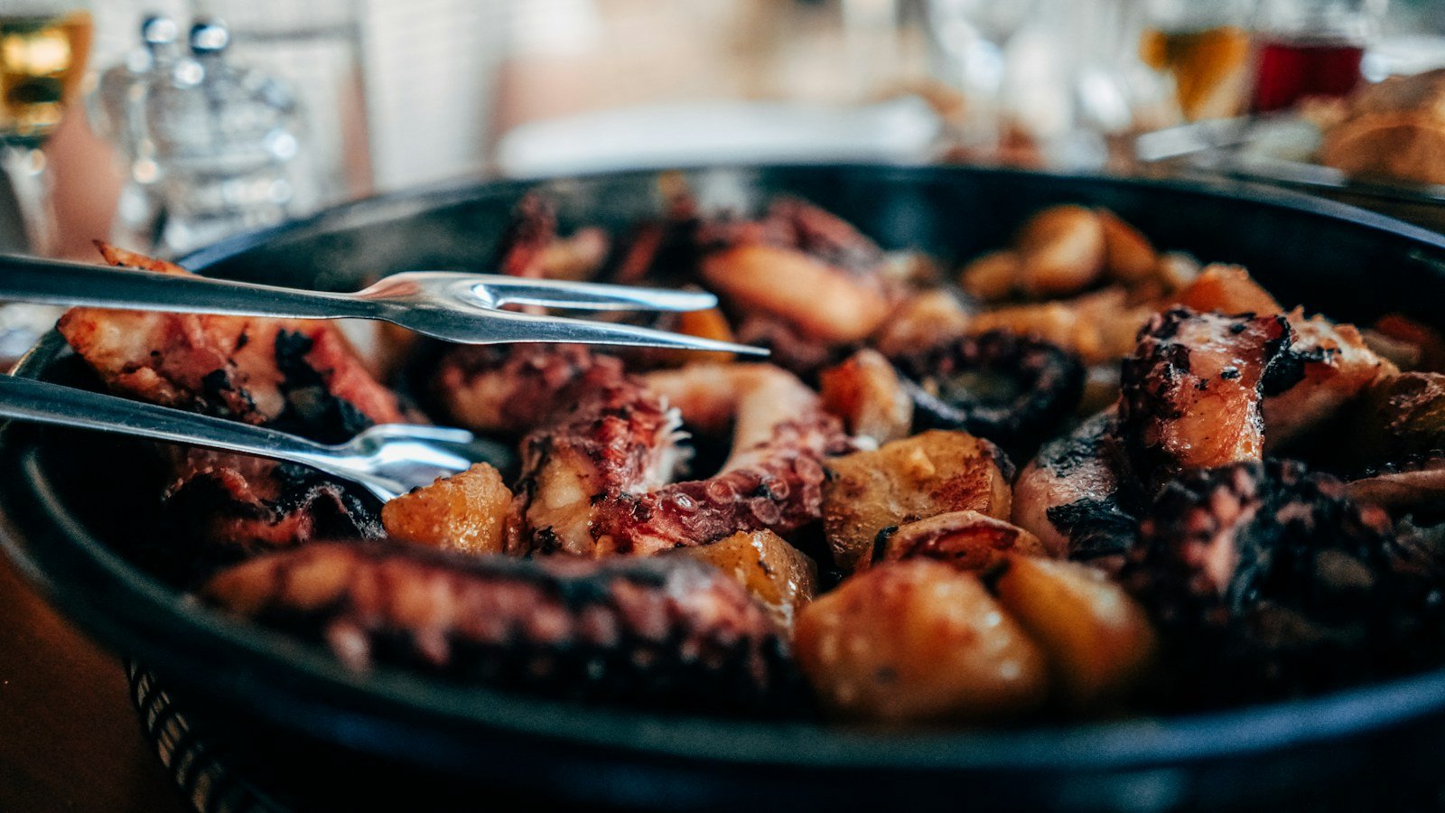 Prepared octopus dish served in a black bowl, illustrative seafood photograph
